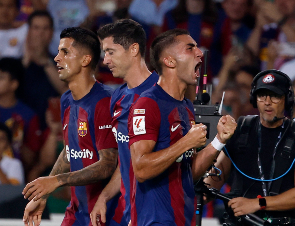 Barcelona's Ferran Torres celebrate scoring his side's third goal during a Spanish La Liga soccer match between Barcelona and Betis at the Olympic Stadium of Montjuic in Barcelona, Spain, Saturday, Sept. 16, 2023. (AP Photo/Joan Monfort)