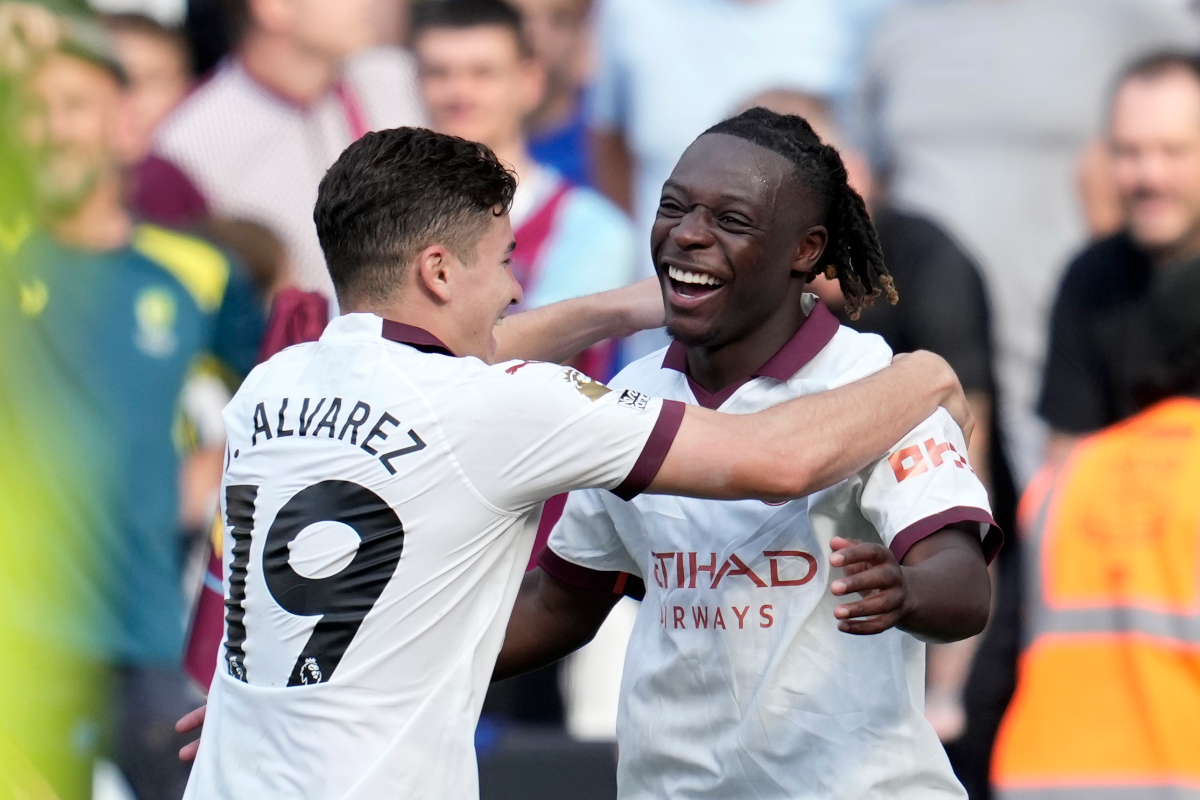 Manchester City's Jeremy Doku celebrates with Julian Alvarez, left, after scoring his side's first goal during the English Premier League soccer match between West Ham United and Manchester City at London stadium in London, Saturday, Sept. 16, 2023. (AP Photo/Kin Cheung)