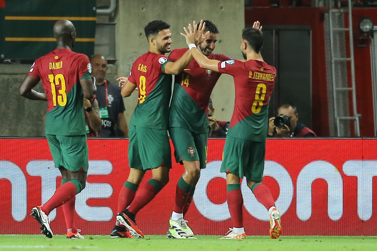 Portugal's Goncalo Inacio, 2nd right, celebrates with Bruno Fernandes, right, and Goncalo Ramos after scoring his side's fourth goal during the Euro 2024 group J qualifying soccer match between Portugal and Luxembourg at the Algarve stadium outside Faro, Portugal, Monday, Sept. 11, 2023. (AP Photo/Joao Matos)