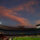 FILE - A general view of the the Camp Nou stadium as the sun sets ahead of the Spanish La Liga soccer match between FC Barcelona and Valladolid CF in Barcelona, Spain, on April 5, 2021. Spanish police raided offices of the Spanish soccer federation on Thursday Sept. 28, 2023 as part of a judicial investigation into the alleged payment of millions of euros over several years by Barcelona soccer club to the vice president of Spain’s football refereeing committee. (AP Photo/Joan Monfort, File)