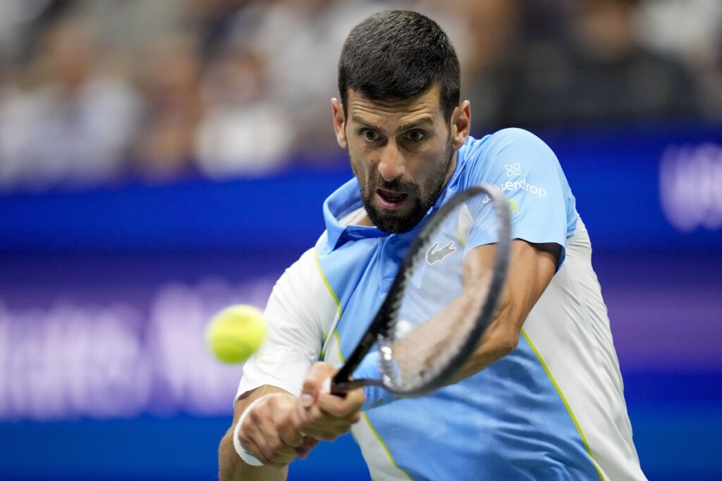 Novak Djokovic, of Serbia, returns a shot to Ben Shelton, of the United States, during the men's singles semifinals of the U.S. Open tennis championships, Friday, Sept. 8, 2023, in New York.