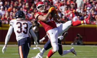 Kansas City Chiefs tight end Travis Kelce catches a pass as Chicago Bears cornerback Jaylon Johnson (33) defends during the first half of an NFL football game Sunday, Sept. 24, 2023, in Kansas City, Mo. (AP Photo/Ed Zurga)