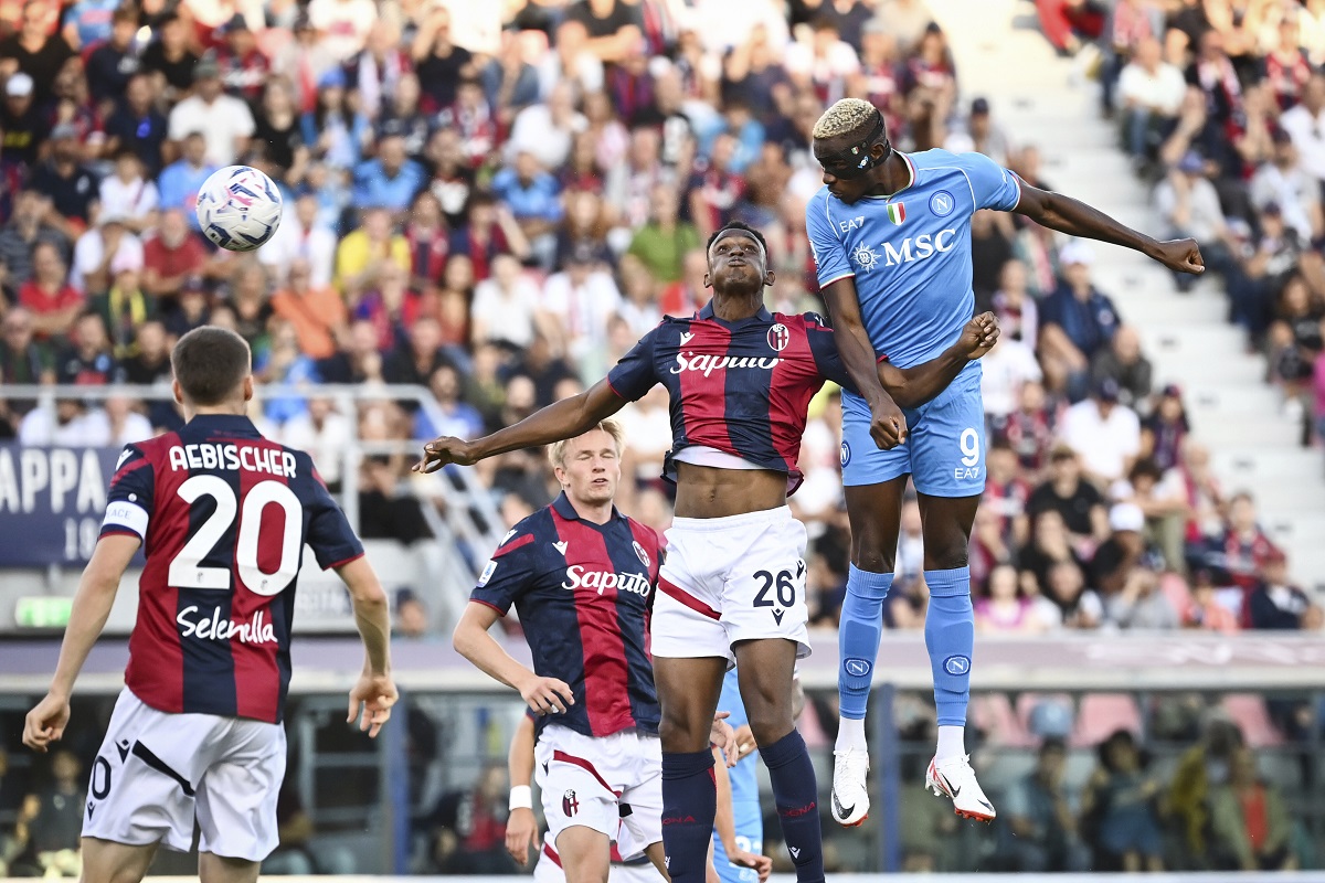 Napoli's Victor Osimhen, top right, heads the ball during the Serie A soccer match between Bologna and Napoli at the Renato Dall'Ara stadium in Bologna, Italy, Sunday, Sept. 24, 2023. (Massimo Paolone/LaPresse via AP)