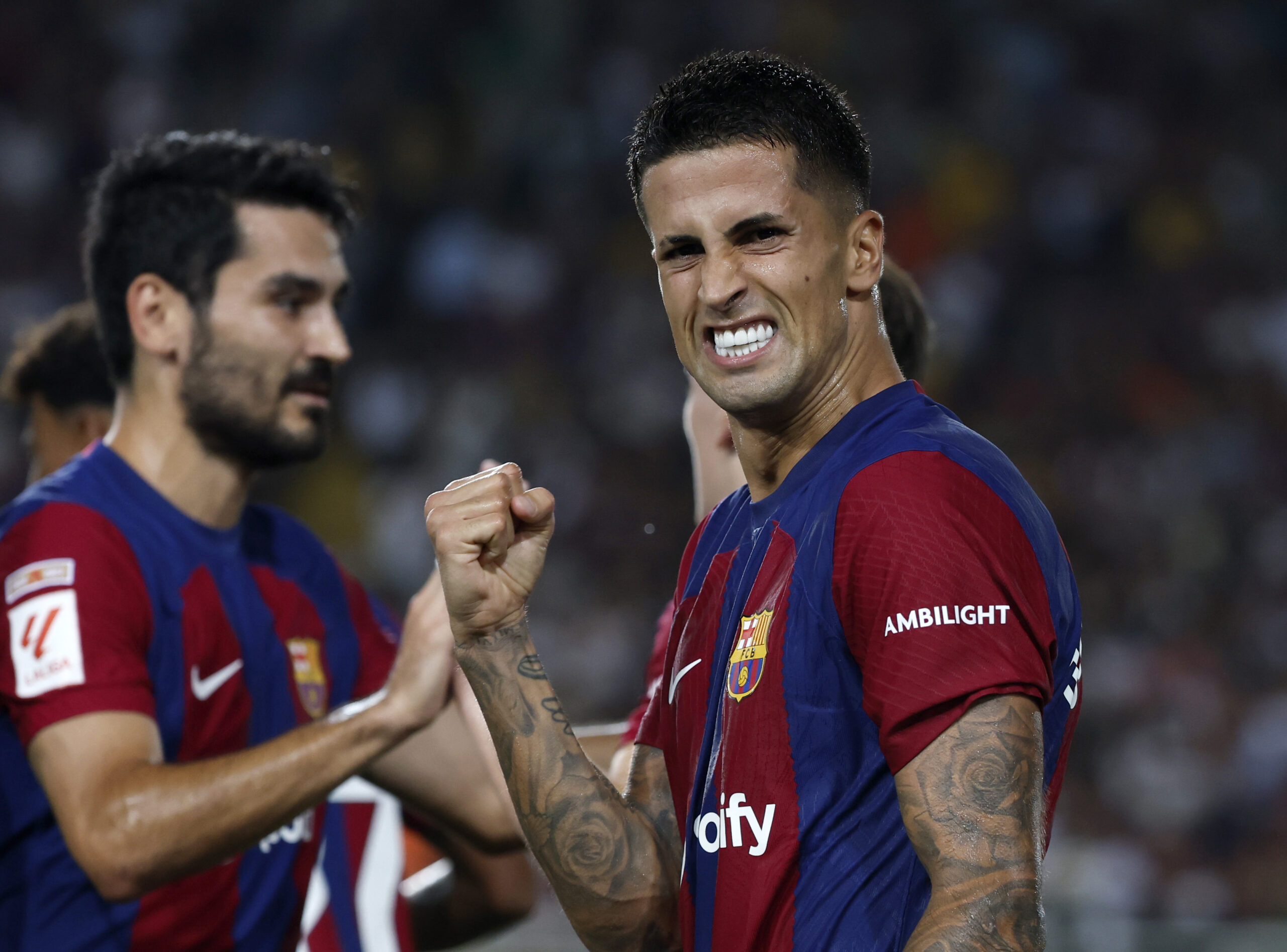 Barcelona's Joao Cancelo celebrates scoring his side's fifth goal during a Spanish La Liga soccer match between Barcelona and Betis at the Olympic Stadium of Montjuic in Barcelona, Spain, Saturday, Sept. 16, 2023. (AP Photo/Joan Monfort)