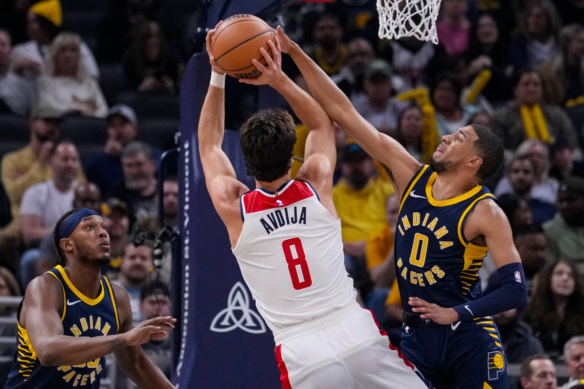 Indiana Pacers guard Tyrese Haliburton (0) blocks the shot of Washington Wizards forward Deni Avdija (8) during the first half of an NBA basketball game in Indianapolis, Wednesday, Oct. 25, 2023. (AP Photo/Michael Conroy)