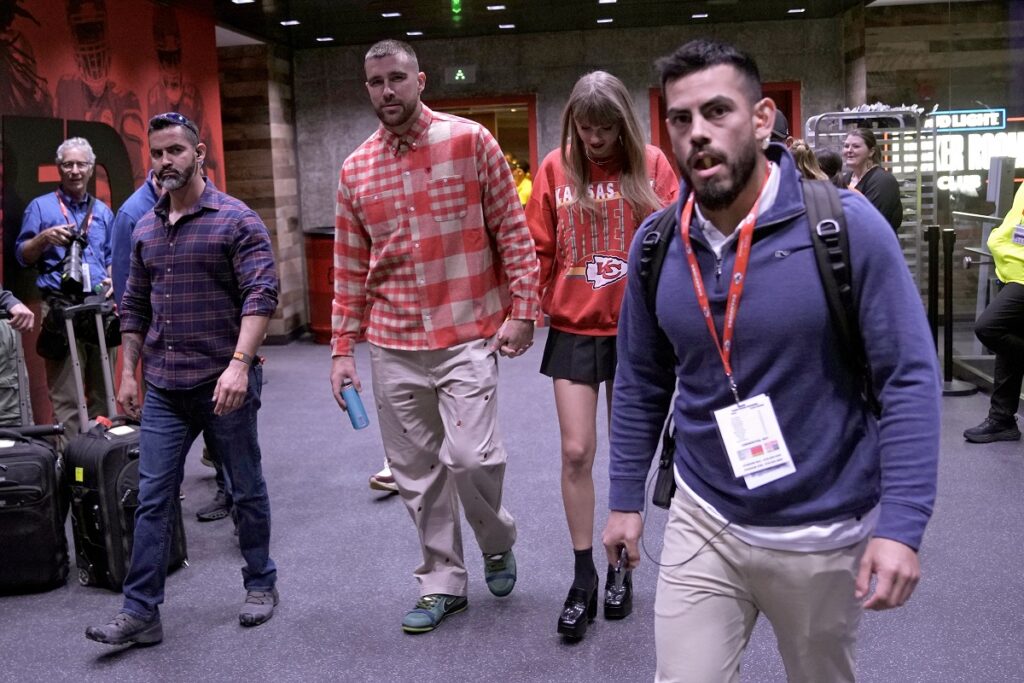 Kansas City Chiefs tight end Travis Kelce, center left, and singer Taylor Swift leave Arrowhead stadium after an NFL football game between the Chiefs and the Los Angeles Chargers, Sunday, Oct. 22, 2023, in Kansas City, Mo. (AP Photo/Charlie Riedel)