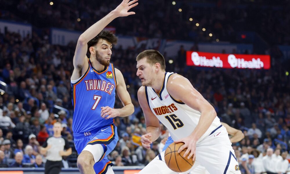 Denver Nuggets center Nikola Jokic (15) drives against Oklahoma City Thunder forward Chet Holmgren (7) in the first half of an NBA basketball game, Sunday, Oct. 29, 2023, in Oklahoma City. (AP Photo/Nate Billings)