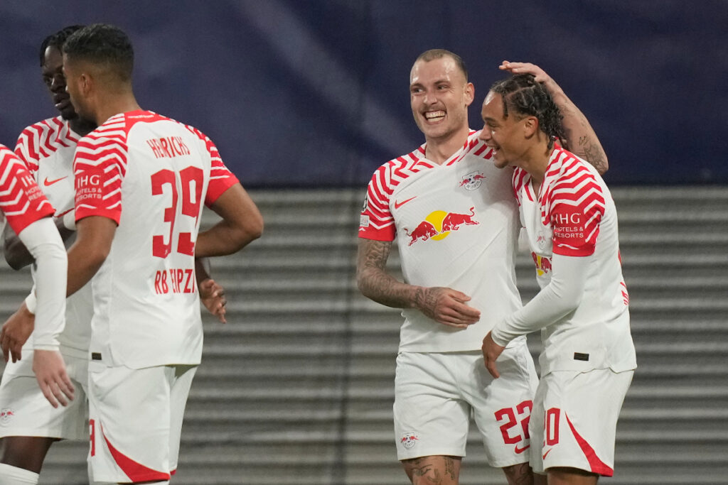 Leipzig's David Raum, centre right, celebrates after scoring his side's opening goal during the group G Champions League soccer match between RB Leipzig and Red Star Belgrade at the Red Bull arena stadium in Leipzig, Germany, Wednesday, Oct. 25, 2023. (AP Photo/Matthias Schrader)