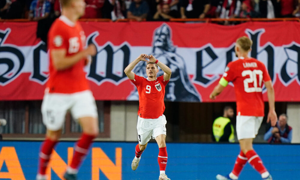 Austria's Marcel Sabitzer, centre, celebrates after scoring his side's second goal during the Euro 2024 group F qualifying soccer match between Austria and Belgium at the Ernst Happel stadium in Vienna, Austria, Friday, Oct. 13, 2023. (AP Photo/Florian Schroetter)