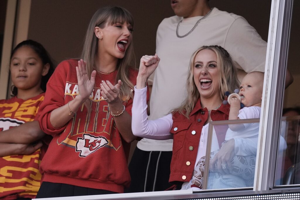 Taylor Swift cheers alongside Brittany Mahomes, right, before the start of an NFL football game between the Kansas City Chiefs and the Los Angeles Chargers Sunday, Oct. 22, 2023, in Kansas City, Mo. (AP Photo/Charlie Riedel)