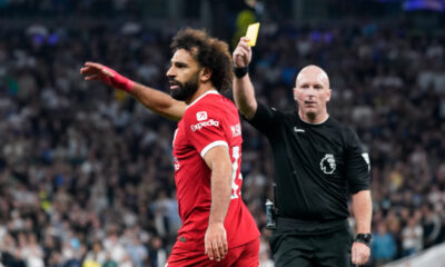 Referee Simon Hooper shows the yellow card to Liverpool's Mohamed Salah during the English Premier League soccer match between Tottenham Hotspur and Liverpool at the Tottenham Hotspur Stadium, in London, England, Saturday, Sept. 30, 2023. (AP Photo/Alberto Pezzali)