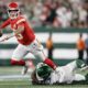 Kansas City Chiefs quarterback Patrick Mahomes (15) is tripped up by New York Jets linebacker Bryce Huff (47) as he throws during the second quarter of an NFL football game, Sunday, Oct. 1, 2023, in East Rutherford, N.J. (AP Photo/Adam Hunger)