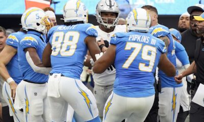 Las Vegas Raiders defensive tackle Jerry Tillery, center, is confronted by Los Angeles Chargers player after Tillery hit Chargers quarterback Justin Herbert late as Herbert ran out of bounds during the first half of an NFL football game Sunday, Oct. 1, 2023, in Inglewood, Calif. (AP Photo/Ryan Sun)