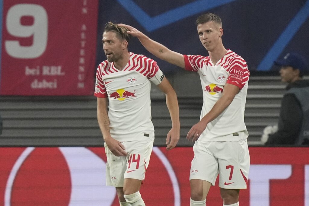 Leipzig's Dani Olmo, right, celebrates after scoring his side's third goal during the group G Champions League soccer match between RB Leipzig and Red Star Belgrade at the Red Bull arena stadium in Leipzig, Germany, Wednesday, Oct. 25, 2023. (AP Photo/Matthias Schrader)