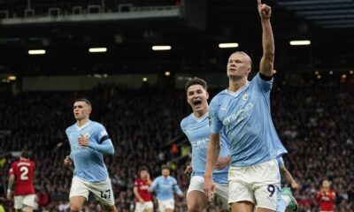 Manchester City's Erling Haaland, right, celebrates after scoring his side's opening goal from a penalty kick during the English Premier League soccer match between Manchester United and Manchester City at Old Trafford stadium in Manchester, England, Sunday, Oct. 29, 2023. (AP Photo/Dave Thompson)