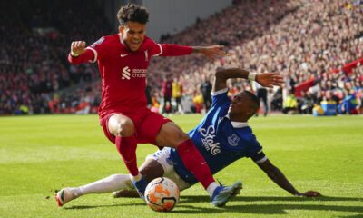 Liverpool's Luis Diaz, left, challenges for the ball with Everton's Ashley Young during the English Premier League soccer match between Liverpool and Everton, at Anfield in Liverpool, England, Saturday, Oct. 21, 2023. (AP Photo/Jon Super)