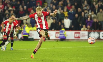 Sheffield United's Oli McBurnie shoots to score from the penalty spot during the English Premier League soccer match between Sheffield United and Manchester United at Bramall Lane in Sheffield, England, Saturday, Oct. 21, 2023. (AP Photo/Jon Super)