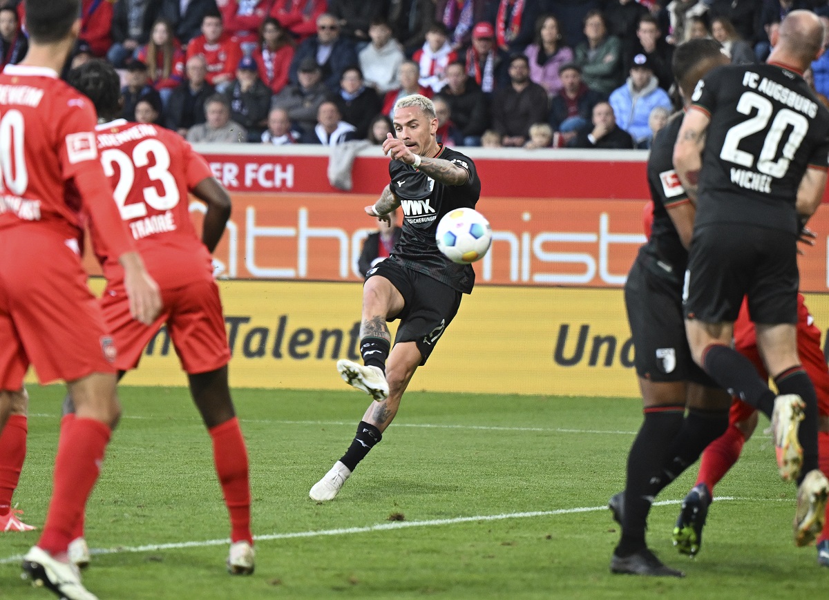 Augsburg's Philip Tietz takes a shot on goal during the German Bundesliga soccer match between FC Augsburg and 1. FC Heidenheim at the Voith-Arena in Heidenheim, Germany, Sunday, Oct. 22, 2023. (Bernd Wei'brod/dpa via AP)