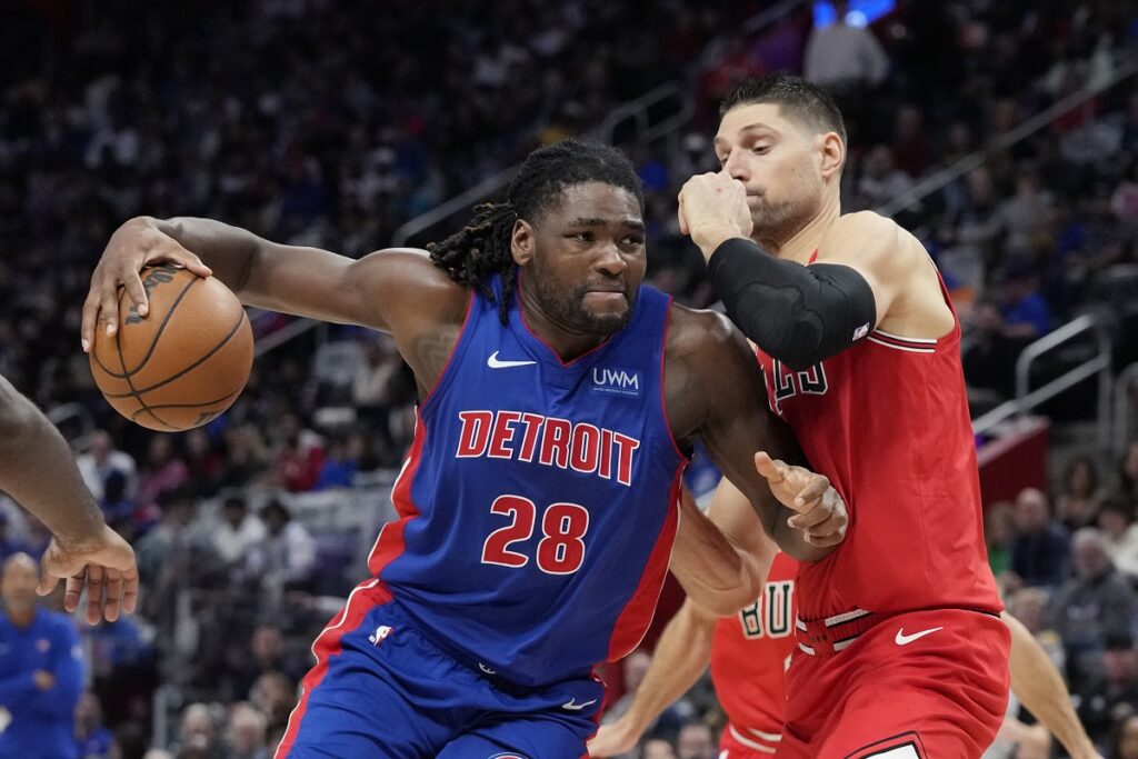 Detroit Pistons center Isaiah Stewart (28) drives as Chicago Bulls center Nikola Vucevic (9) defends during the first half of an NBA basketball game, Saturday, Oct. 28, 2023, in Detroit. (AP Photo/Carlos Osorio)