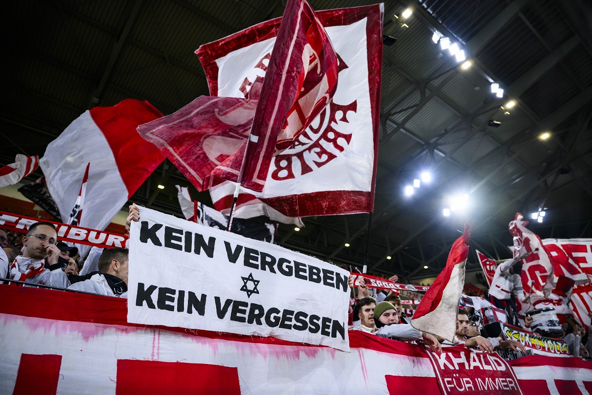 Freiburg's fans hold a poster with the inscription "No forgiveness - no forgetting" during the Europa League Group A soccer match between SC Freiburg and TSC Backa Topola in Freiburg, Germany, Thursday, Nov. 9, 2023. (Tom Weller/dpa via AP)