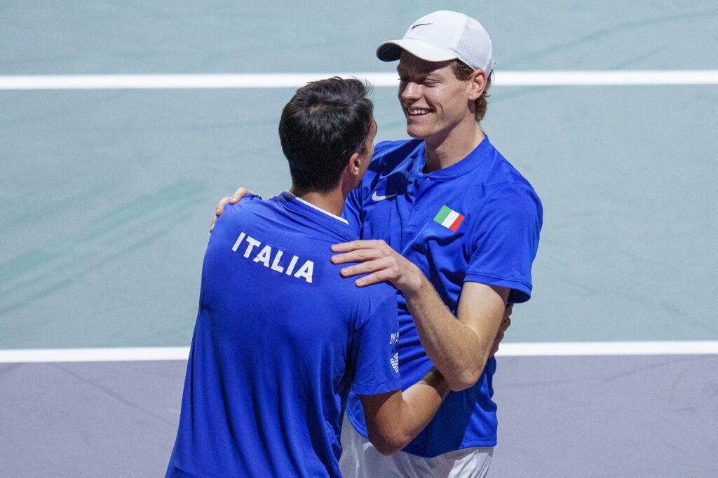 Italy's Jannik Sinner, right, celebrates with his teammate Lorenzo Sonego after winning against Serbia's Novak Djokovic and Miomir Kecmanovic during a Davis Cup semi-final doubles tennis match between Italy and Serbia in Malaga, Spain, Saturday, Nov. 25, 2023. (AP Photo/Manu Fernandez)