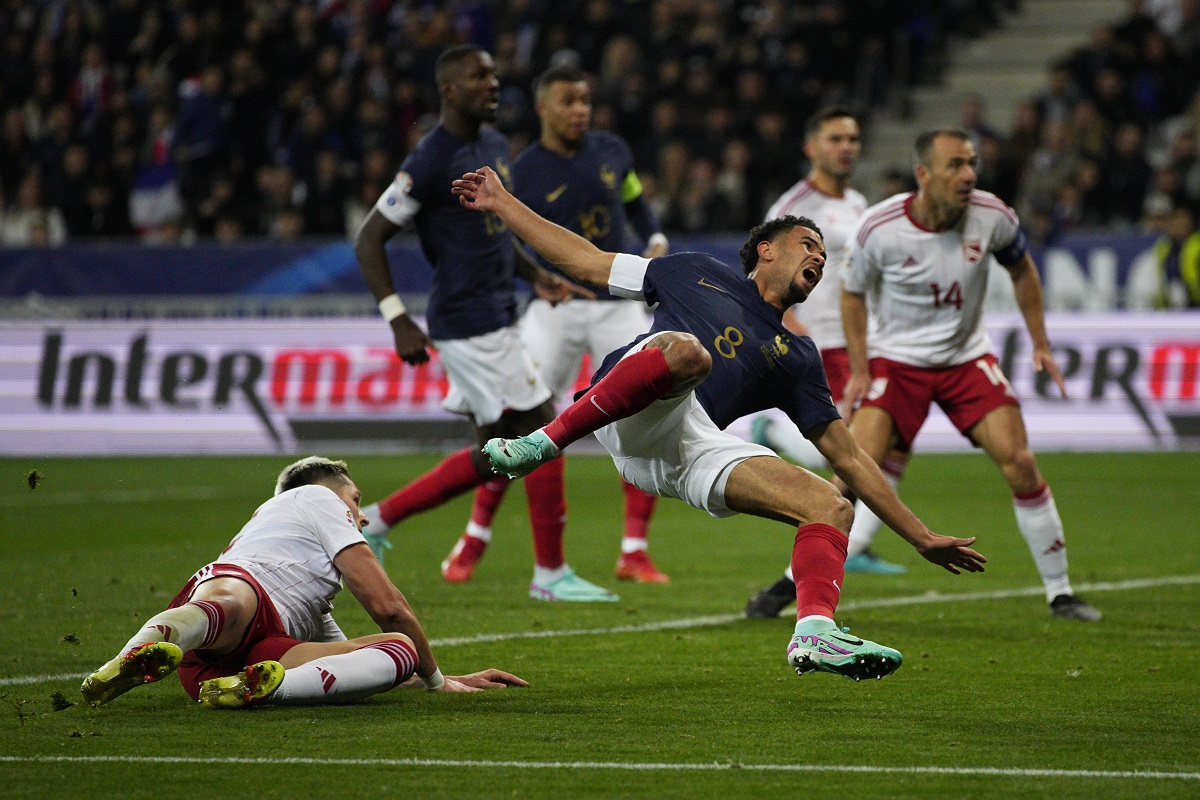 Gibraltar's Ethan Santos, left, fouls France's Warren Zaire-Emery for a red card during the Euro 2024 group B qualifying soccer match between France and Gibraltar in Nice, France, Saturday, Nov. 18, 2023. (AP Photo/Daniel Cole)