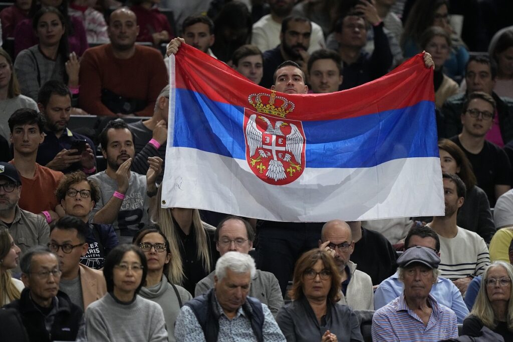 A man shows a Serbian flag during the final match between Serbia's Novak Djokovic and Bulgaria's Grigor Dimitrov at the Paris Masters tennis tournament in Paris, Sunday, Nov. 5, 2023. (AP Photo/Michel Euler)