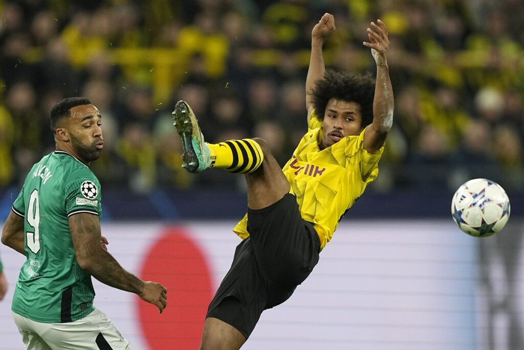 Dortmund's Karim Adeyemi, right, fights for the ball by Newcastle's Callum Wilson during the Champions League Group F soccer match between Borussia Dortmund and Newcastle United in Dortmund, Germany, Tuesday, Nov. 7, 2023. (AP Photo/Martin Meissner)