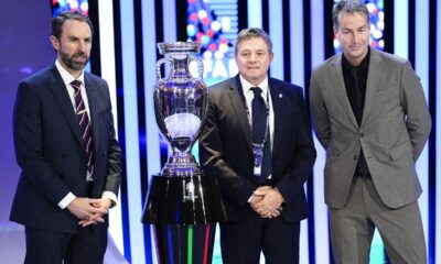 The head coaches of England Gareth Southgate, right, Serbia Dragan Stojkovic, center, and Denmark Kasper Hjulmand, left, pose next to the trophy after the draw for the UEFA Euro 2024 soccer tournament finals in Hamburg, Germany, Saturday, Dec. 2, 2023. (AP Photo/Martin Meissner)