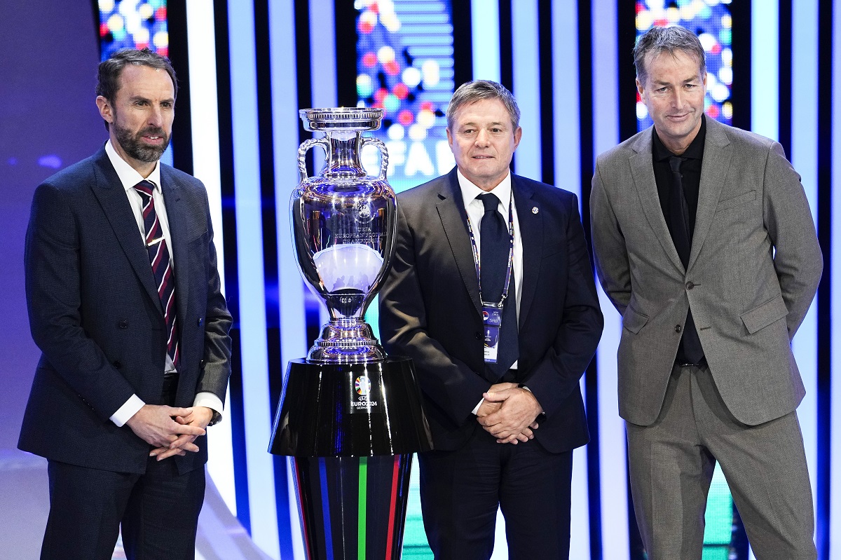The head coaches of England Gareth Southgate, right, Serbia Dragan Stojkovic, center, and Denmark Kasper Hjulmand, left, pose next to the trophy after the draw for the UEFA Euro 2024 soccer tournament finals in Hamburg, Germany, Saturday, Dec. 2, 2023. (AP Photo/Martin Meissner)