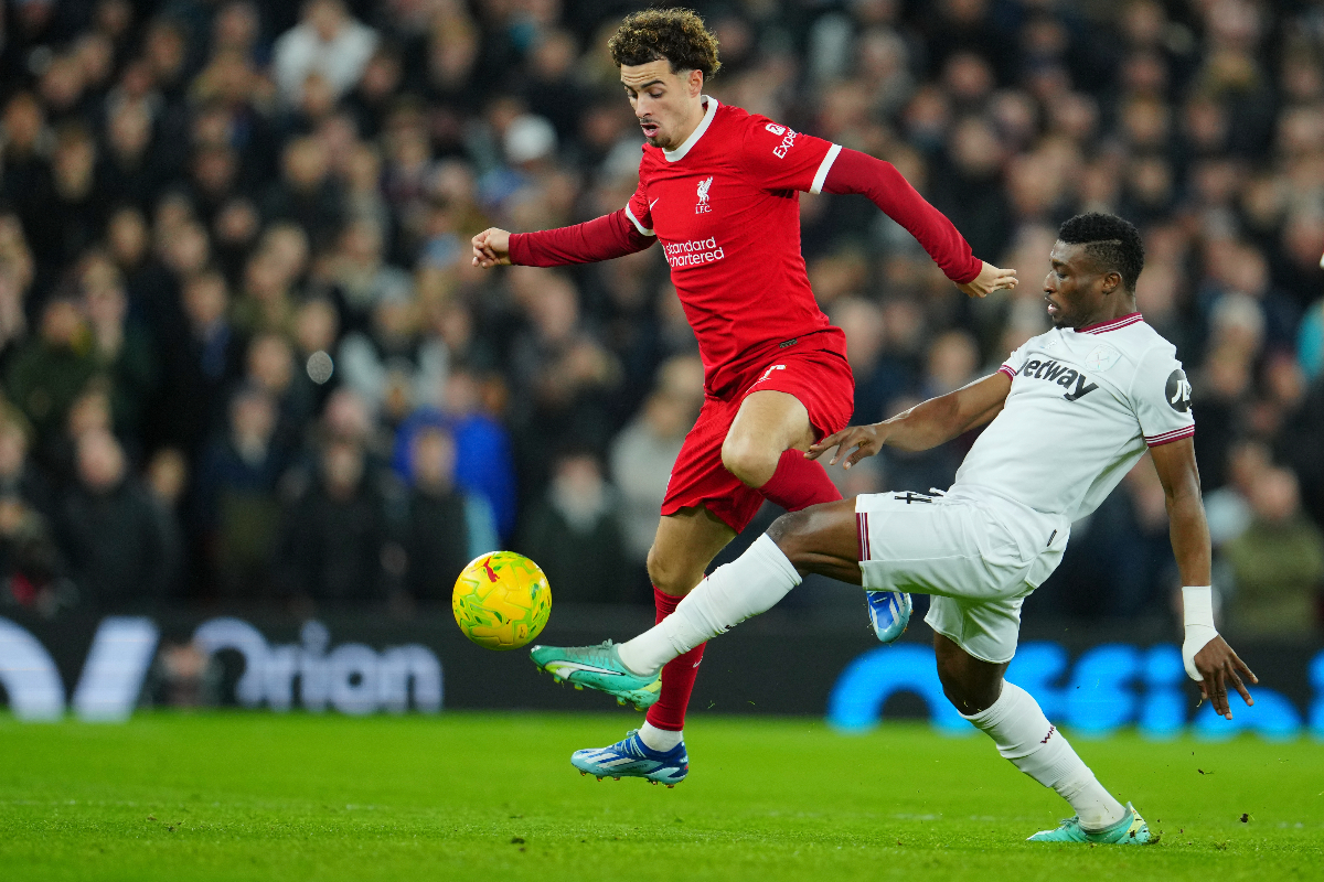 West Ham's Mohammed Kudus, right, and Liverpool's Curtis Jones battle for the ball during the English League Cup quarterfinal soccer match between Liverpool and West Ham United at the Anfield stadium in Liverpool, England, Wednesday, Dec. 20, 2023. (AP Photo/Jon Super)