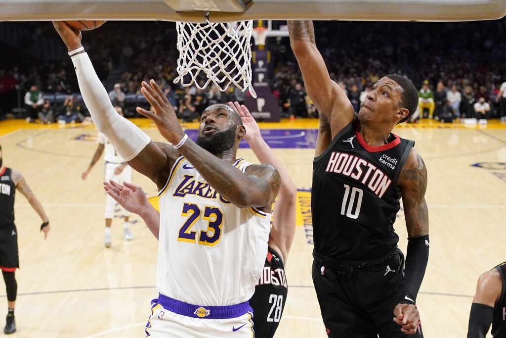 Los Angeles Lakers forward LeBron James, left, shoots as Houston Rockets forward Jabari Smith Jr. defends during the first half of an NBA basketball game Saturday, Dec. 2, 2023, in Los Angeles. (AP Photo/Mark J. Terrill)