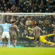 Tottenham's Son Heung-min, center, scores an own goal to tie the match 1-1 during the English Premier League soccer match between Manchester City and Tottenham Hotspur at Etihad stadium in Manchester, England, Sunday, Dec. 3, 2023. (AP Photo/Dave Thompson)