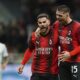 AC Milan's Theo Hernandez, left, celebrates with teammate Luka Jović after scoring his side's opening goal during a Serie A soccer match between AC Milan and Fiorentina, in Milan's San Siro Stadium, Italy, Saturday, Nov. 25, 2023. (Spada/LaPresse via AP)