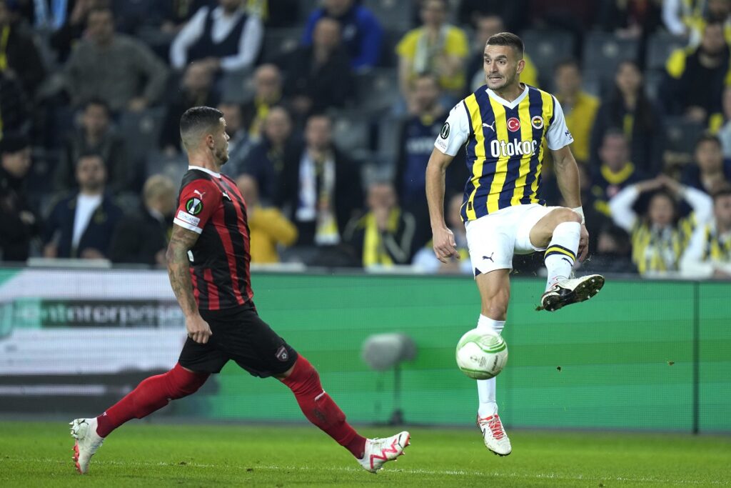 Fenerbahce's Dusan Tadic, right, plays the ball next to Spartak Trnava's Kristisn Kostrna during the Europa Conference League group H soccer match between Fenerbahce and Spartak Trnava at Sukru Saracoglu stadium in Istanbul, Turkey, Thursday, Dec. 14, 2023. (AP Photo/Francisco Seco)