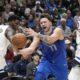 Dallas Mavericks guard Luka Doncic (77) is fouled by Minnesota Timberwolves guard Anthony Edwards (5) during the first half of an NBA basketball game in Dallas, Thursday, Dec. 14, 2023. (AP Photo/LM Otero)