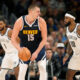 Denver Nuggets center Nikola Jokic, left, is defended by Brooklyn Nets forward Royce O'Neale during the second half of an NBA basketball game Thursday, Dec. 14, 2023, in Denver. (AP Photo/David Zalubowski)