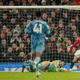 Manchester United's Alejandro Garnacho, right, scores his side's opening goal during the English Premier League soccer match between Manchester United and Aston Villa at the Old Trafford stadium in Manchester, England, Tuesday, Dec. 26, 2023. (AP Photo/Dave Thompson)