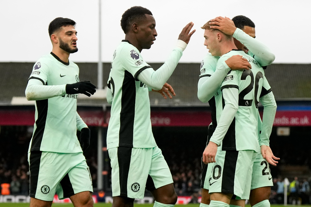 Chelsea's Cole Palmer, right, celebrates with teammates after scoring his sides first goal during the English Premier League soccer match between Luton Town and Chelsea, at Kenilworth Road, in Luton, England, Saturday, Dec. 30, 2023. (AP Photo/Alastair Grant)