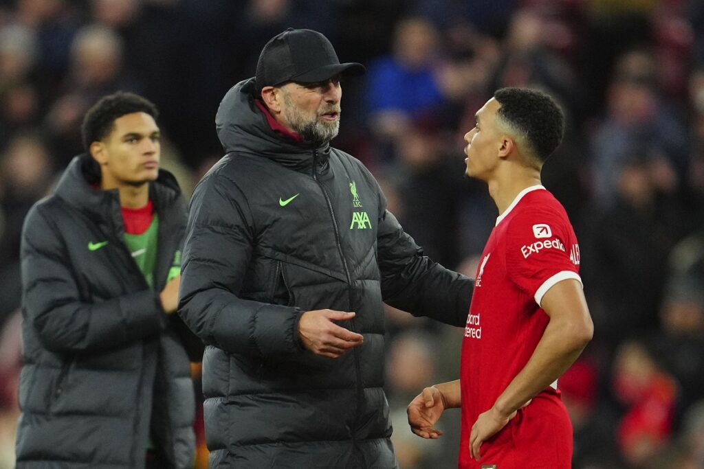 Liverpool's manager Jurgen Klopp, left, speaks with his player Trent Alexander-Arnold at the end of the English Premier League soccer match between Liverpool and Arsenal at Anfield stadium in Liverpool, England, Saturday, Dec. 23, 2023. (AP Photo/Jon Super)