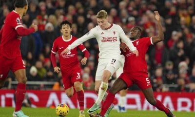 Manchester United's Rasmus Hojlund, centre, challenges for the ball with Liverpool's Ibrahima Konate, right, and Liverpool's Wataru Endo during the English Premier League soccer match between Liverpool and Manchester United at the Anfield stadium in Liverpool, England, Sunday, Dec.17, 2023. (AP Photo/Jon Super)
