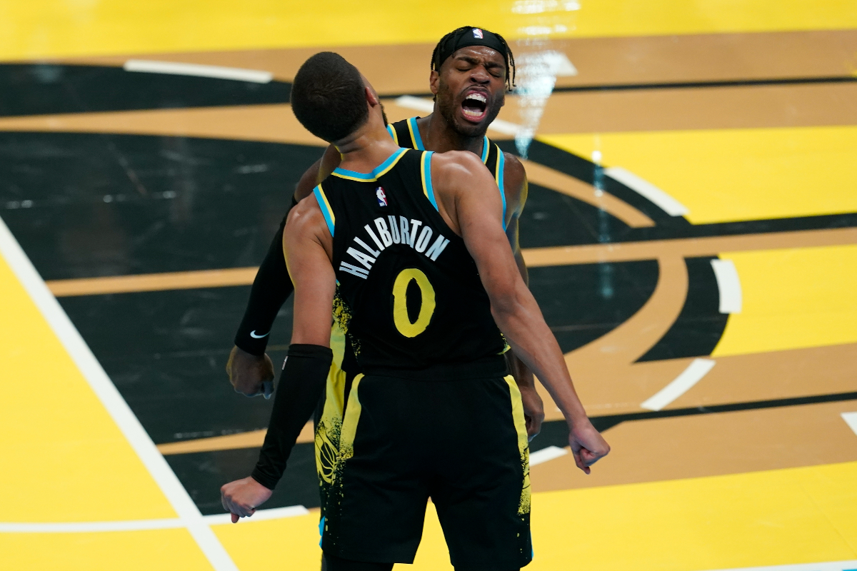 Indiana Pacers' Tyrese Haliburton (0) and Buddy Hield, right, celebrate during the second half of an NBA basketball In-Season Tournament game against the Boston Celtics, Monday, Dec. 4, 2023, in Indianapolis. (AP Photo/Darron Cummings)