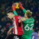 Liverpool's goalkeeper Caoimhin Kelleher, right, and Sheffield United's Anel Ahmedhodzic jump for the ball during the English Premier League soccer match between Sheffield United and Liverpool at Bramall Lane in Sheffield, England, Wednesday, Dec. 6, 2023. (AP Photo/Jon Super)