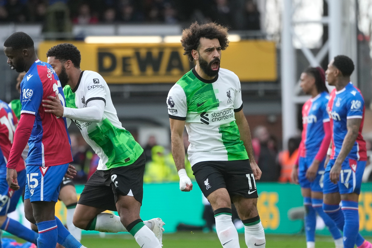Liverpool's Mohamed Salah, centre, celebrates after scoring his side's opening goal during the Premier League soccer match between Crystal Palace and Liverpool at Selhurst Park, in London, England, Saturday, Dec. 9, 2023. (AP Photo/Kin Cheung)