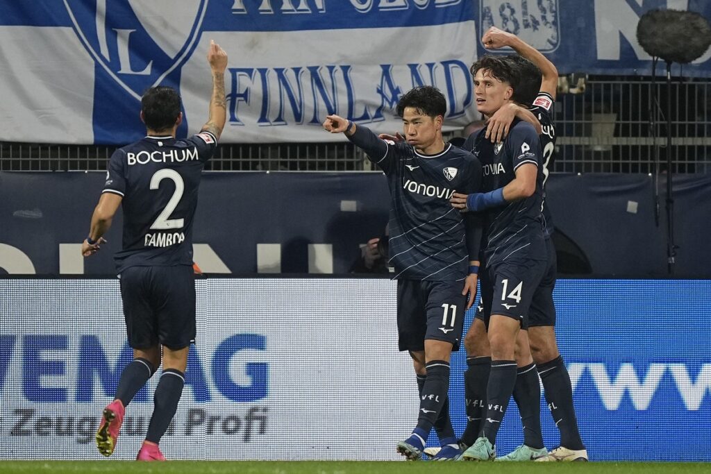 Bochum's Takuma Asano, center, celebrates after he scored the opening goal during the German Bundesliga soccer match between VfL Bochum and Union Berlin in Bochum, Germany, Saturday, Dec. 16, 2023. (AP Photo/Martin Meissner)