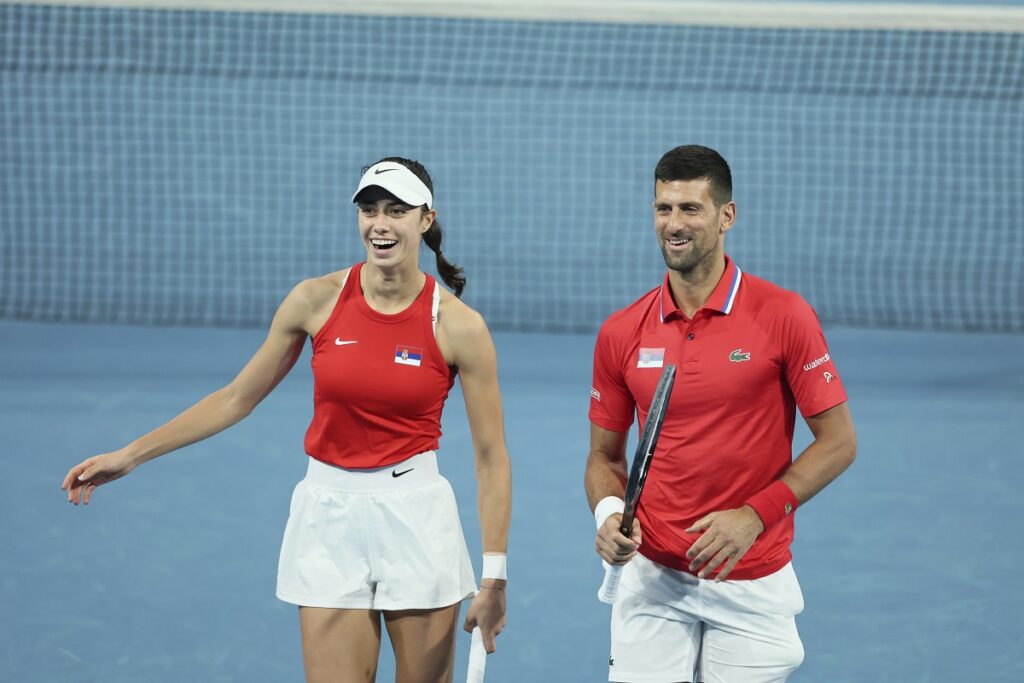 Novak Djokovic and Olga Danilovic of Serbia laugh on court during their mixed doubles match against Qinwen Zheng and Zhizhen Zhang of China during the United Cup tennis tournament in Perth, Australia, Sunday, Dec. 31, 2023. (AP Photo/Trevor Collens)