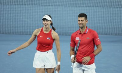 Novak Djokovic and Olga Danilovic of Serbia laugh on court during their mixed doubles match against Qinwen Zheng and Zhizhen Zhang of China during the United Cup tennis tournament in Perth, Australia, Sunday, Dec. 31, 2023. (AP Photo/Trevor Collens)