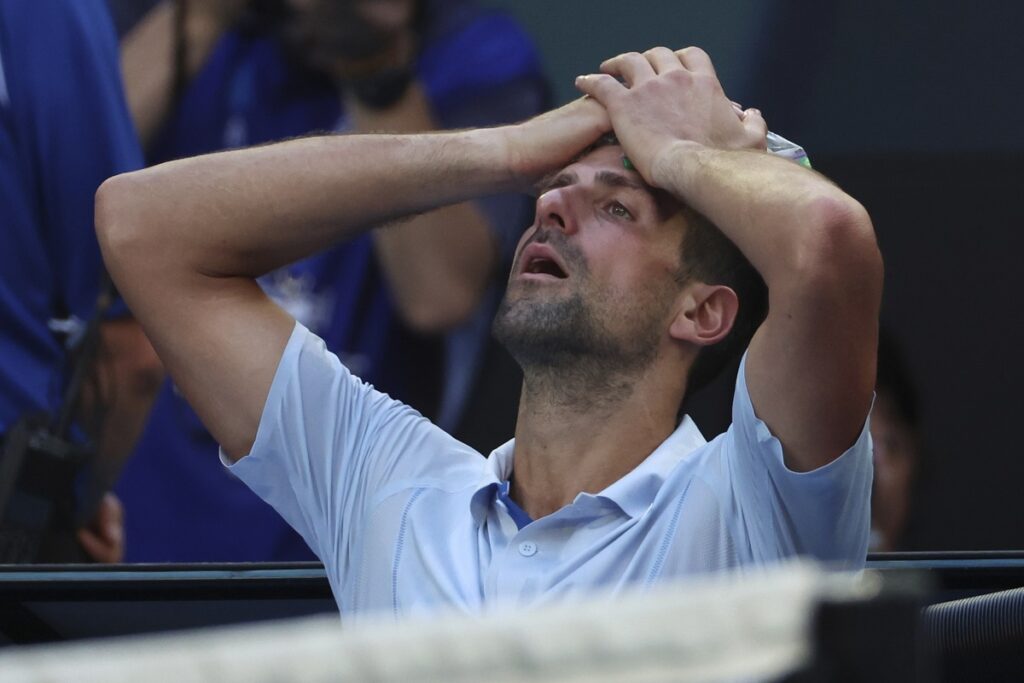 Novak Djokovic of Serbia places a bag of ice on his head during a break in his quarterfinal against Taylor Fritz of the U.S. at the Australian Open tennis championships at Melbourne Park, Melbourne, Australia, Tuesday, Jan. 23, 2024. (AP Photo/Asanka Brendon Ratnayake)