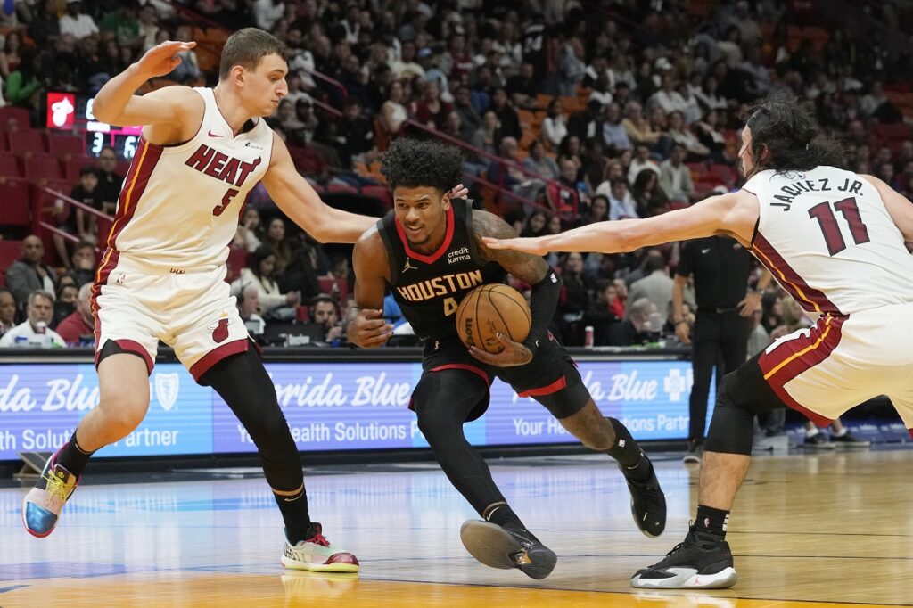 Miami Heat forward Nikola Jovic (5) and guard Jaime Jaquez Jr. (11) defend Houston Rockets guard Jalen Green (4) during the second half of an NBA basketball game, Monday, Jan. 8, 2024, in Miami. (AP Photo/Marta Lavandier)