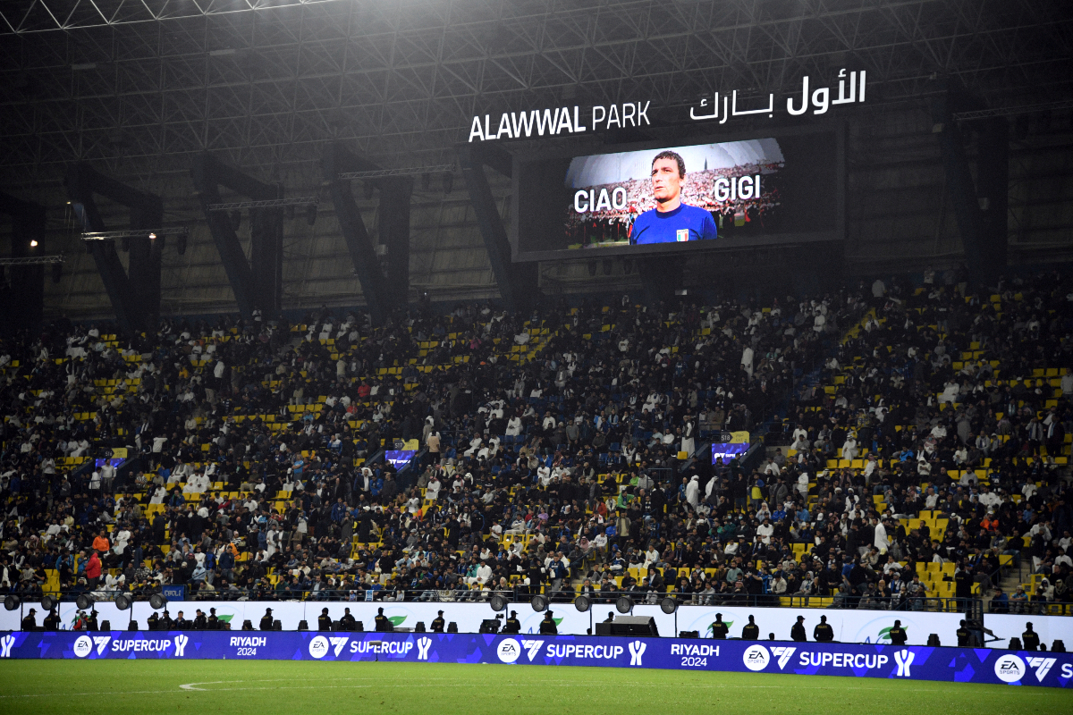 An image of Gigi Riva is projected on a giant screen ahead of the Italian Super Cup final soccer match between Inter Milan and Napoli at Al Awwal Park Stadium in Riyadh, Saudi Arabia, Monday, Jan. 22, 2024. Italy’s all-time leading goalscorer Luigi Riva has died. He was 79. The Italian soccer federation has confirmed the news and tributes have started flooding in for Riva. Riva remains Italy’s leading goalscorer, having netted 35 times in 42 appearances. As a player, he helped the Azzurri win the European Championship in 1968 and finish runners-up at the World Cup, two years later.He was also team manager of the national team from 1990-2013 and was instrumental in Italy winning its fourth World Cup in 2006. (Massimo Paolone/LaPresse via AP)